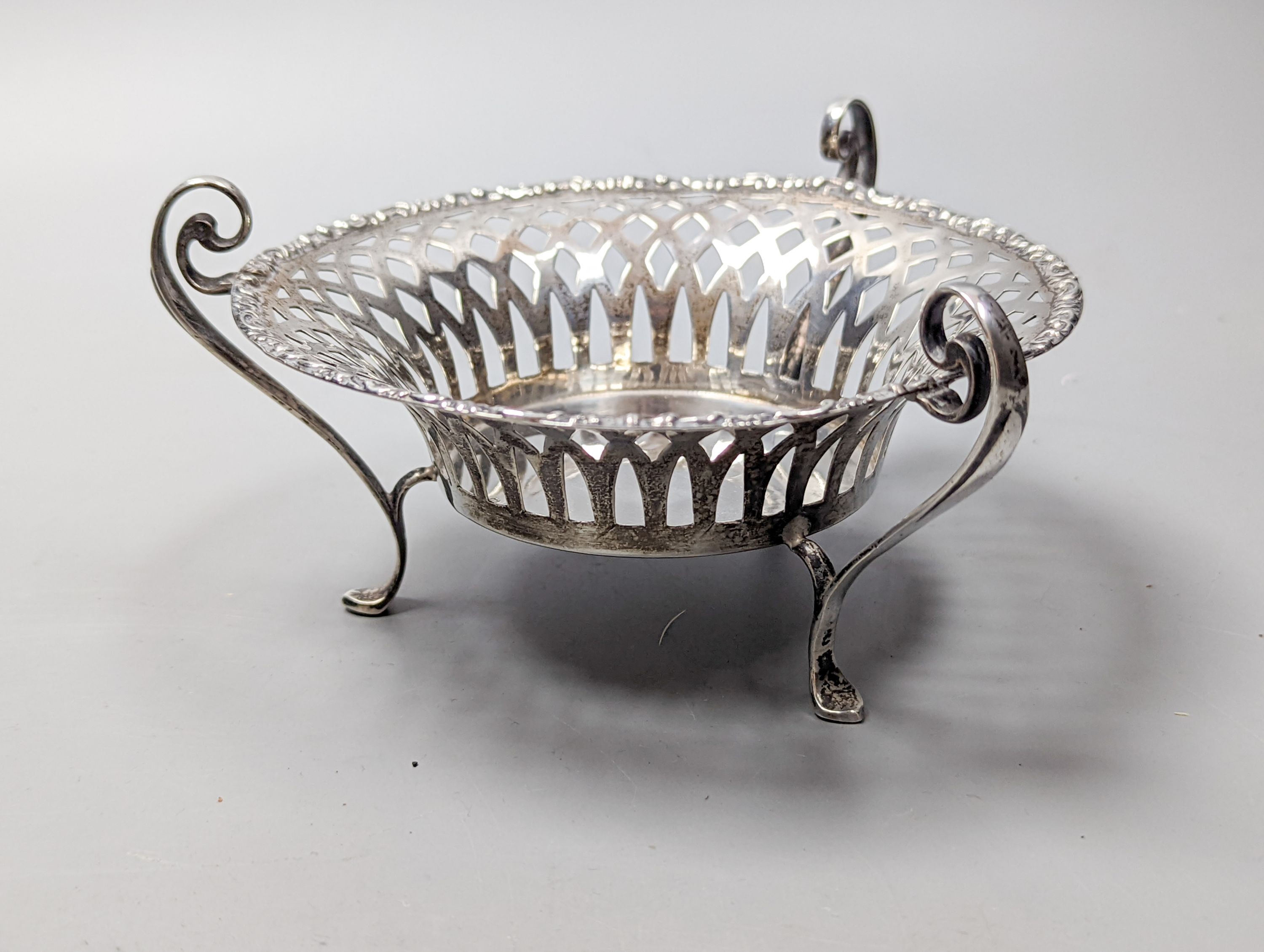 A George V silver sauceboat by Mappin & Webb, Birmingham, 1911, an Edwardian silver tri-handled bowl, a late Victorian repousse silver box and a George V silver sifter spoon, 11oz.